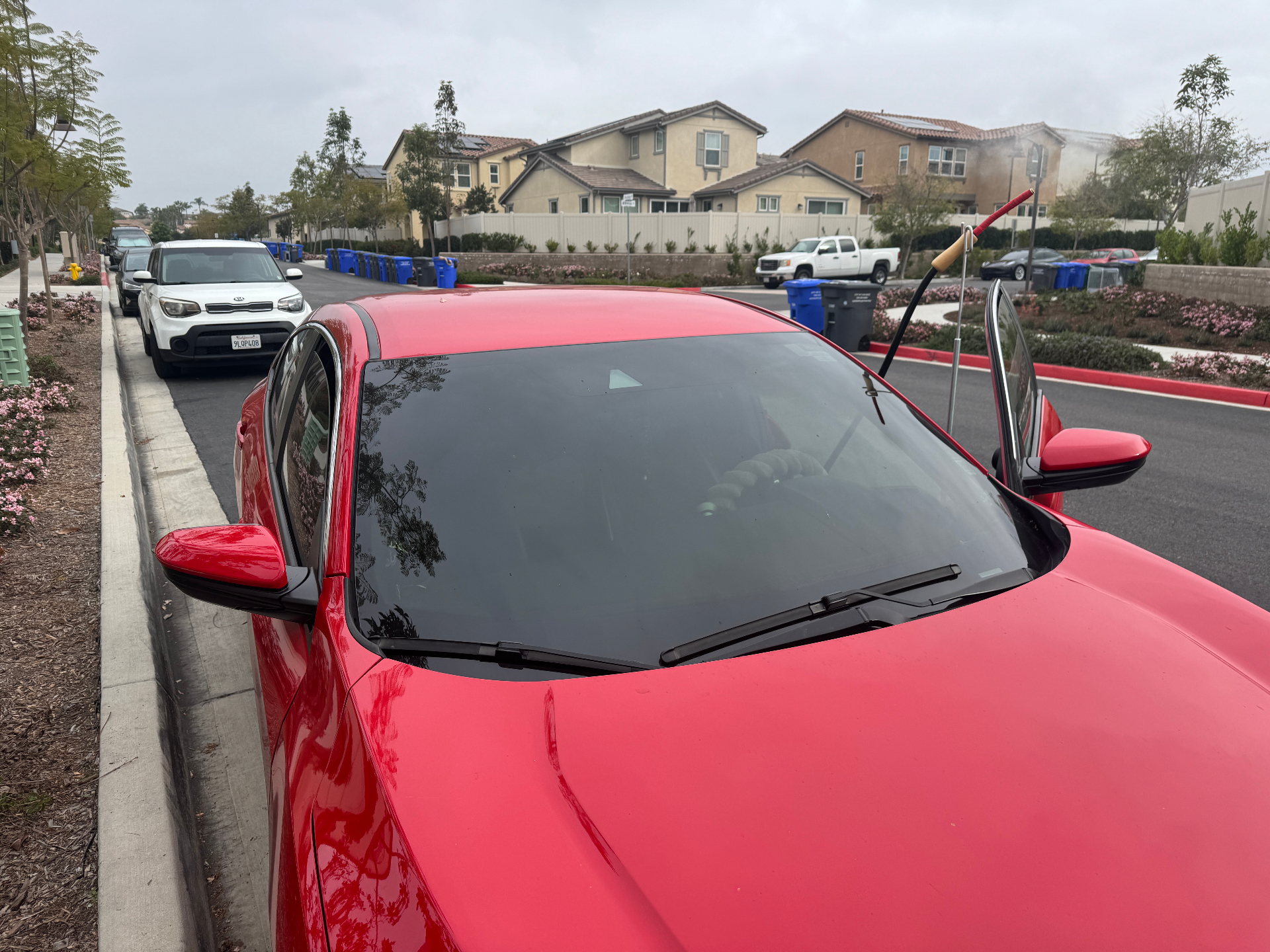 Professional window tint removal on a red Honda Civic by BestAutoTechs in San Diego