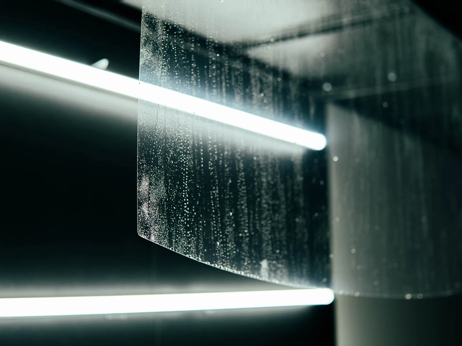 Close-up of optically clear ExoShield ULTRA windshield film held under studio light
