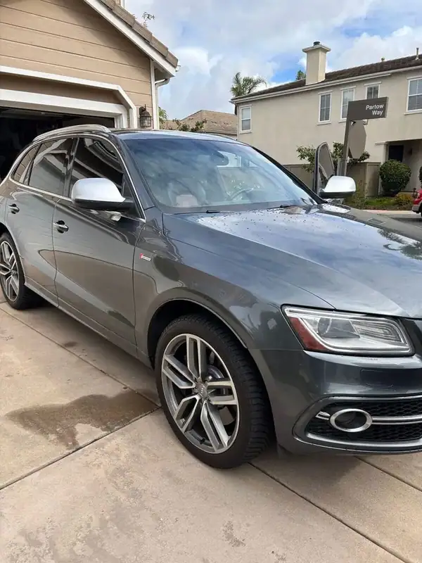 2015 Audi SQ5 Supercharged front three-quarter view with white mirror caps after HiTek ceramic two-front tint install — mobile window tinting San Diego