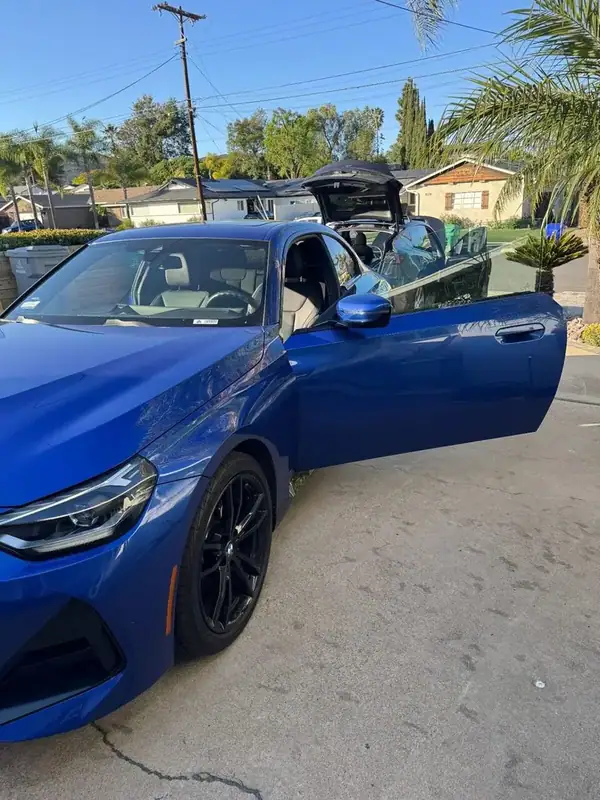 BMW 230i driver side with door open showing ceramic window tint — mobile tinting San Diego
