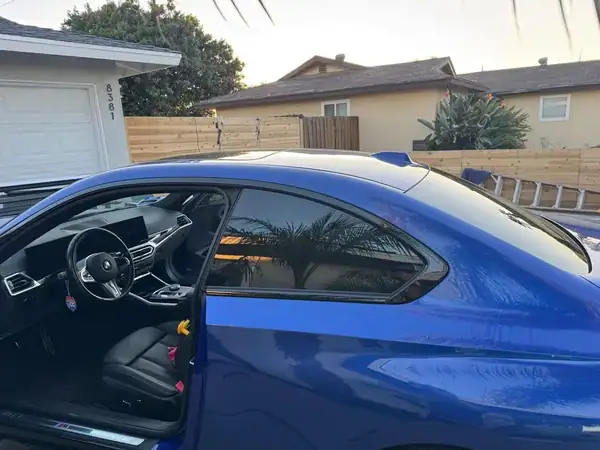 BMW 230i rear quarter view showing ceramic tint on side windows — San Diego mobile service