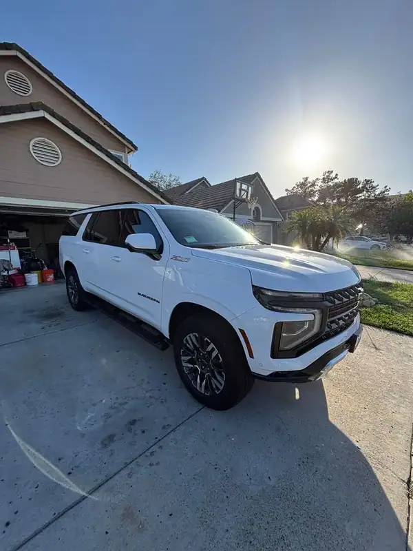 Summit White 2025 Chevrolet Suburban Z71 with full HiTek ceramic window tint installed by BestAutoTechs mobile window tinting in San Diego