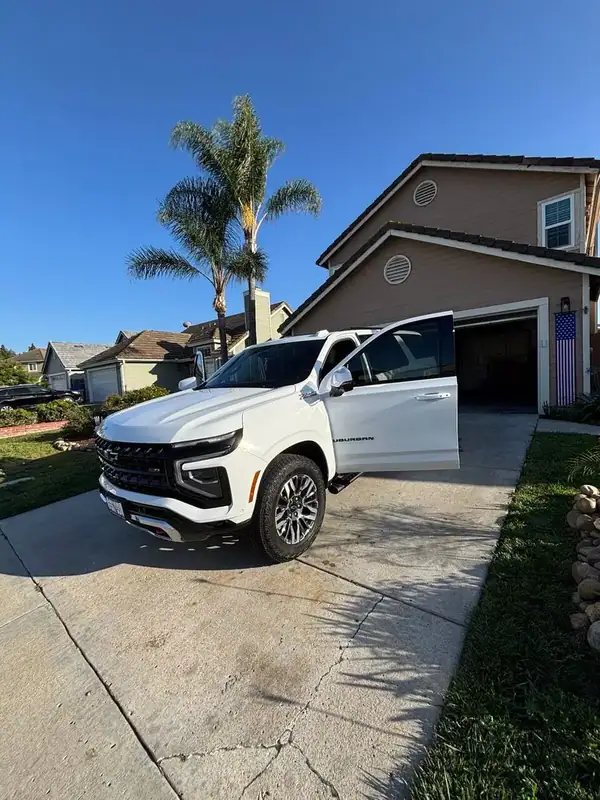 2025 Chevy Suburban Z71 front three-quarter view with driver door open after full HiTek ceramic window tint install — BestAutoTechs San Diego mobile