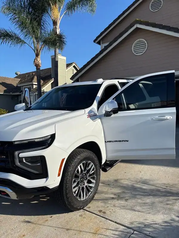 2025 Chevy Suburban Z71 driver-side close-up showing matched front and rear door HiTek ceramic tint and SUBURBAN badge — BestAutoTechs San Diego mobile