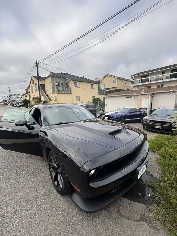 Black Dodge Challenger R/T with driver door open showing freshly installed ceramic window tint on door glass — BestAutoTechs San Diego mobile