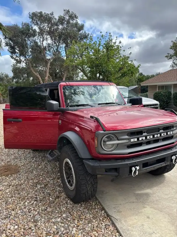 Red Ford Bronco Big Bend front three-quarter view with driver door open showing dark ceramic window tint — Ramona San Diego County mobile service