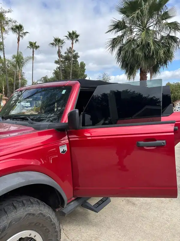 Red Ford Bronco Big Bend driver side close-up showing freshly installed dark ceramic IR window tint — BestAutoTechs Ramona mobile install