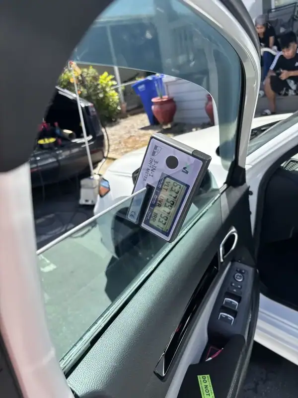 Honda Civic driver-side front window during 70% ceramic IR tint installation — mobile window tinting San Diego