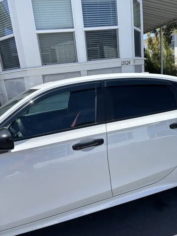 Honda Civic driver-side detail showing finished 70% ceramic IR tint on front window — clean factory-style finish