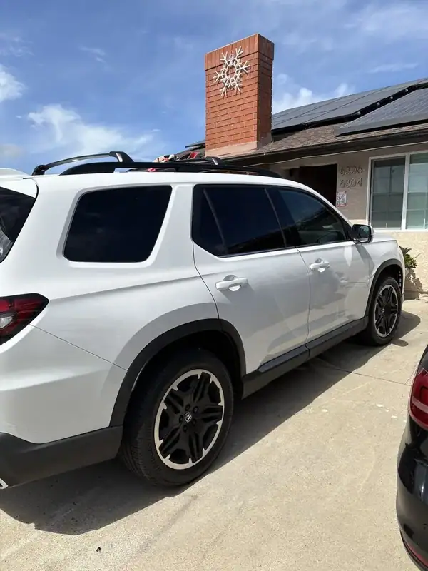 2026 Honda Pilot Platinum White Pearl driver-side rear three-quarter view showing freshly installed ceramic IR window tint on rear door and quarter glass — BestAutoTechs San Diego mobile