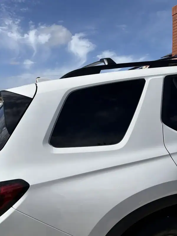 Close-up of 2026 Honda Pilot rear quarter glass with deep ceramic tint matched to factory privacy glass — BestAutoTechs San Diego