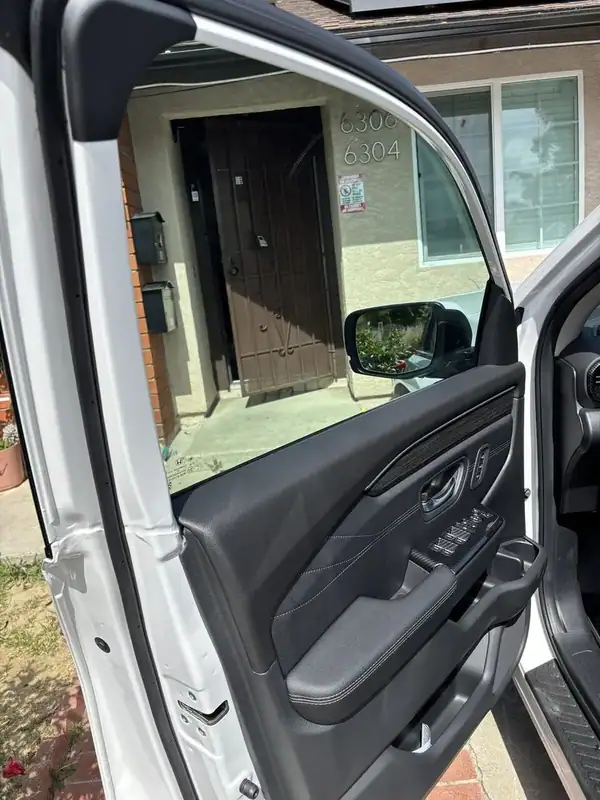 Inside view of 2026 Honda Pilot front driver door showing clean ceramic tint edge and crystal-clear visibility through the film — BestAutoTechs San Diego mobile