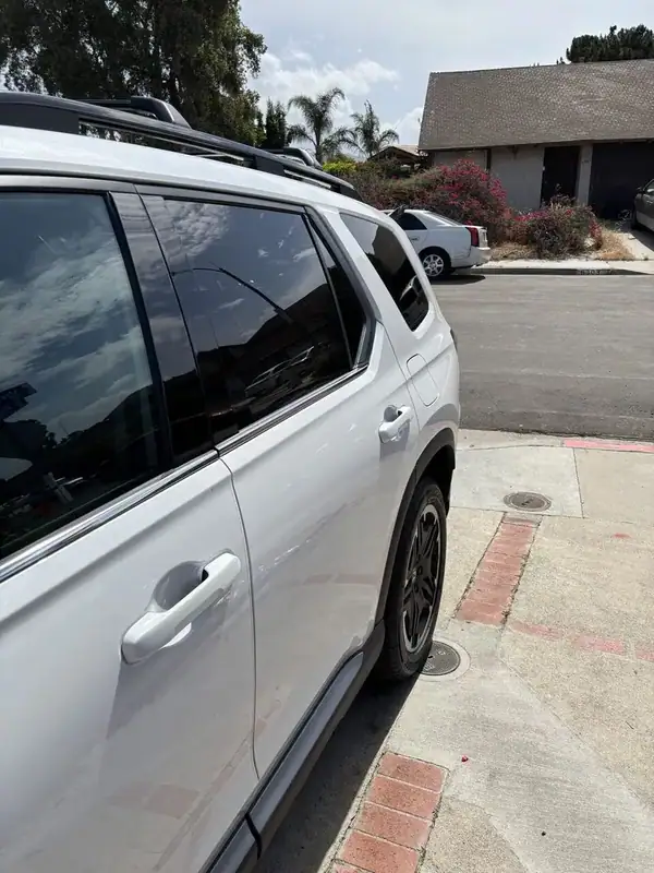 2026 Honda Pilot passenger side profile view showing rear door, quarter glass, and 2nd-row windows after full ceramic IR tint — mobile San Diego
