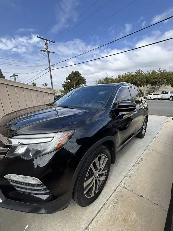 Crystal Black 2017 Honda Pilot Touring AWD front three-quarter view after full ceramic IR window tint install — BestAutoTechs San Diego mobile service