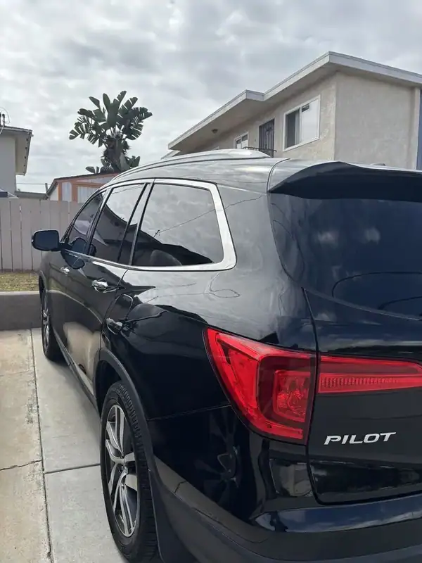 2017 Honda Pilot Touring rear three-quarter view with PILOT badge after full vehicle ceramic window tint install — BestAutoTechs mobile San Diego