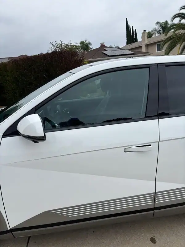 Hyundai Ioniq 5 driver-side profile showing clear 70% HiTek Ceramic front door window tint against Atlas White paint — BestAutoTechs San Diego mobile