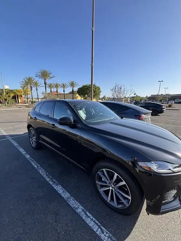 Santorini Black Jaguar F-Pace driver-side high-angle view after ceramic IR front 2-window tint install — clean factory-style finish, BestAutoTechs San Diego mobile