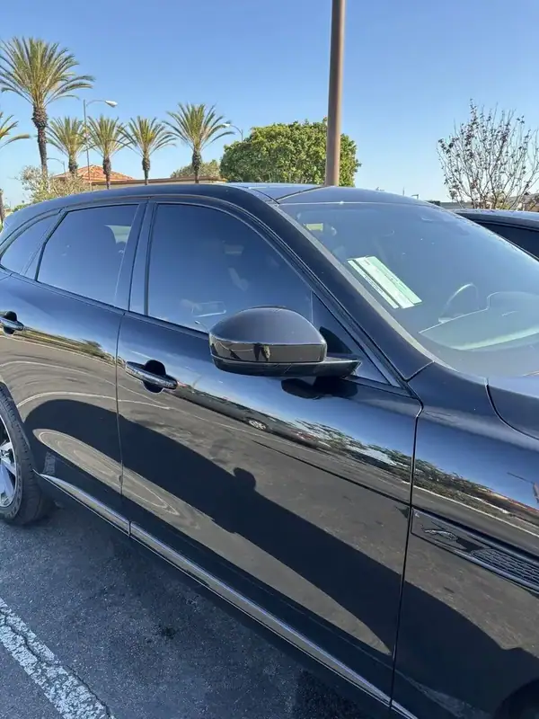 Santorini Black Jaguar F-Pace R-Dynamic driver-side profile after front 2-window 70% ceramic IR tint install — color-matched to factory rear privacy glass, BestAutoTechs San Diego mobile
