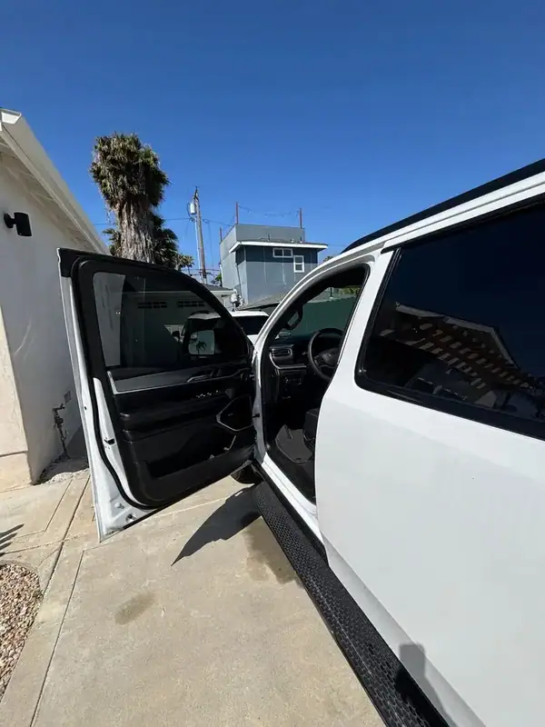 Jeep Wagoneer driver-side door open after full HiTek ceramic IR window tint install — clean factory-style finish on door glass, BestAutoTechs San Diego mobile