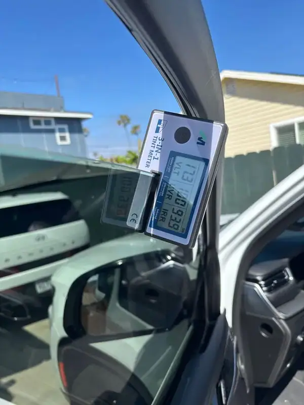 BestAutoTechs 3-in-1 tint meter on Jeep Wagoneer front driver door reading 17.3% VLT, 100% UV rejection, and 93.9% IR (infrared) heat rejection on installed HiTek ceramic IR film — verified on-site in San Diego