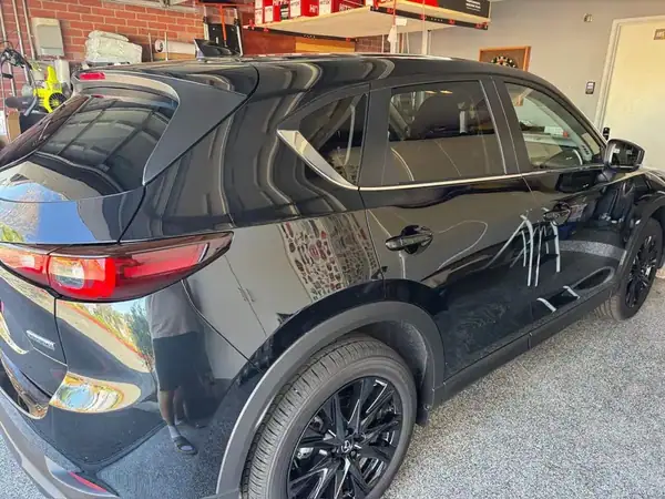 Mazda CX-5 rear quarter view showing dark ceramic tint on side and back glass — mobile tinting San Diego