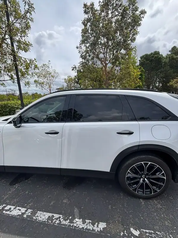 Mazda CX-70 PHEV driver-side profile close-up showing full HiTek ceramic tint and gloss black mirror caps — BestAutoTechs San Diego mobile