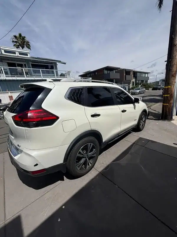 Pearl White Nissan Rogue SV rear three-quarter view after full HiTek ceramic window tint install — BestAutoTechs San Diego mobile