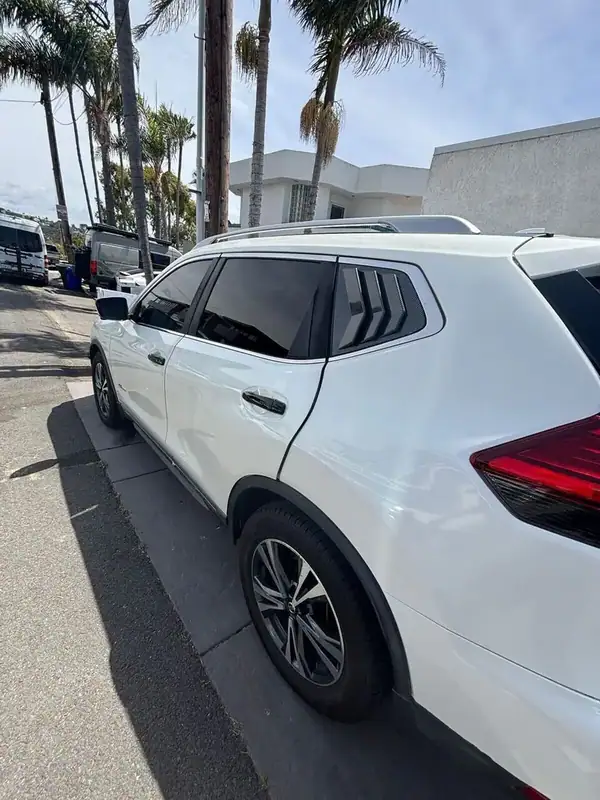 Pearl White Nissan Rogue SV with full HiTek ceramic window tint installed by BestAutoTechs mobile window tinting in San Diego