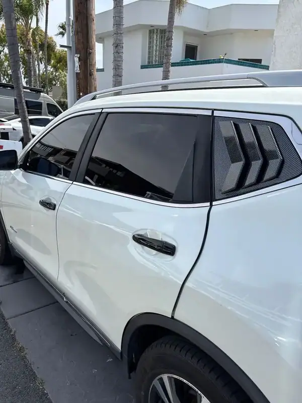 Nissan Rogue SV side profile close-up showing full HiTek ceramic tint and rear quarter trim detail — BestAutoTechs San Diego mobile