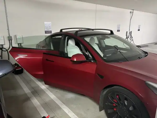 Tesla Model 3 Performance front quarter view at Supercharger after full vehicle ceramic window tint — mobile tinting San Diego