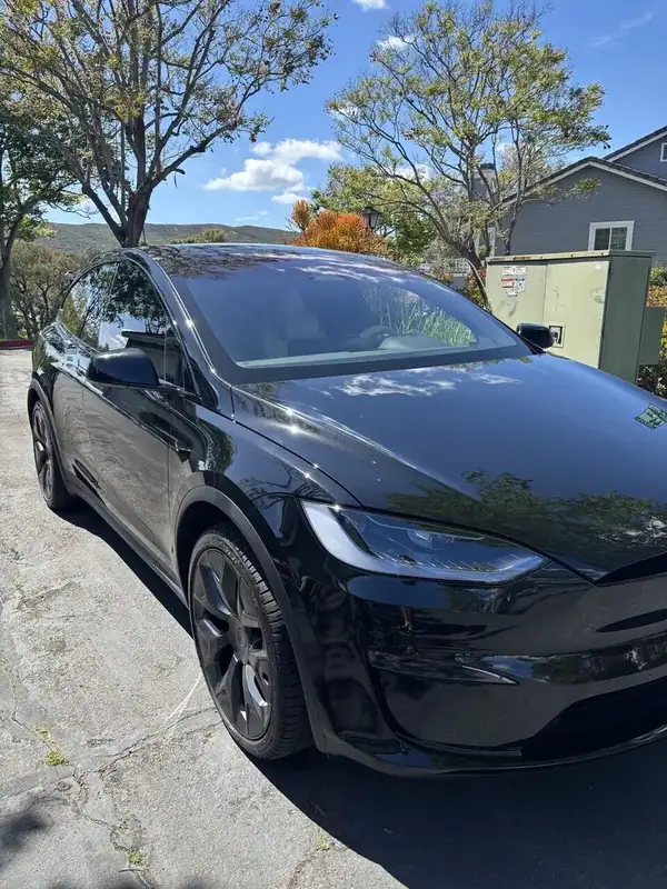 Black Tesla Model X (current-generation falcon-wing refresh) with ceramic window tint installed by BestAutoTechs mobile window tinting in San Diego