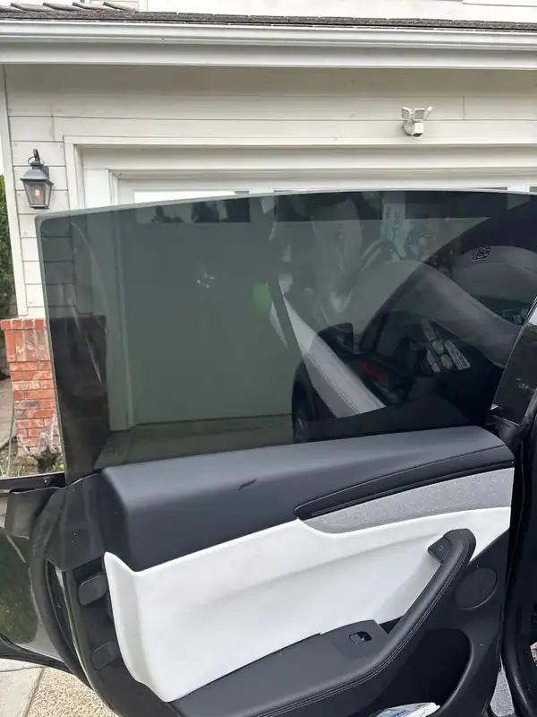 2025 Tesla Model Y rear passenger door open showing dark 5% HiTek ceramic tint on rear glass — BestAutoTechs Orange County mobile install