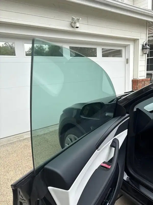 2025 Tesla Model Y front driver door open showing clear 70% HiTek ceramic tint on front window — BestAutoTechs Orange County mobile install