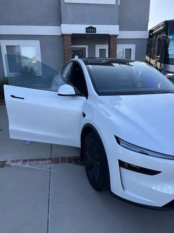 Pearl White 2026 Tesla Model Y Highland Premium passenger side with driver door open showing freshly installed ceramic IR window tint — BestAutoTechs San Diego mobile EV service