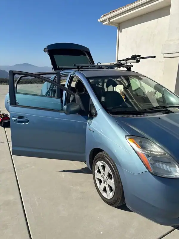 Light blue 2006 Toyota Prius hybrid with full Crystal Clear ceramic window tint installed by BestAutoTechs mobile window tinting in San Diego