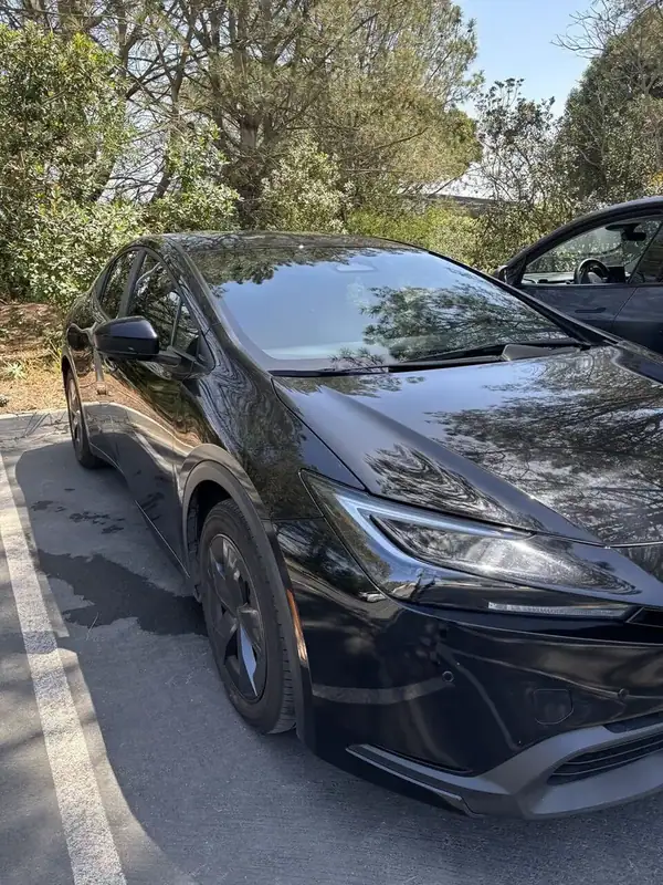 Black Toyota Prius hybrid front three-quarter view with completed ceramic window tint — San Diego mobile auto window tinting