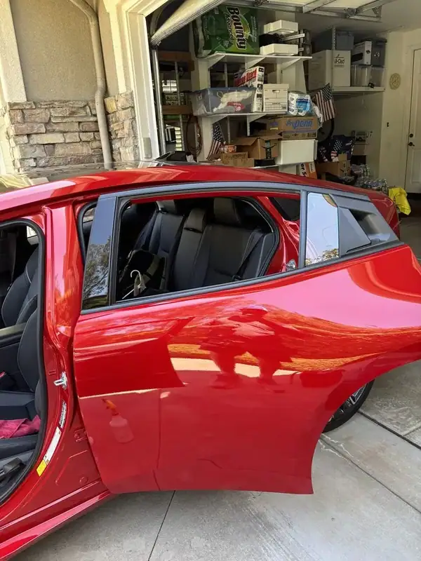 Red Toyota Prius Limited rear door open showing ceramic window tint installation in progress — BestAutoTechs San Diego