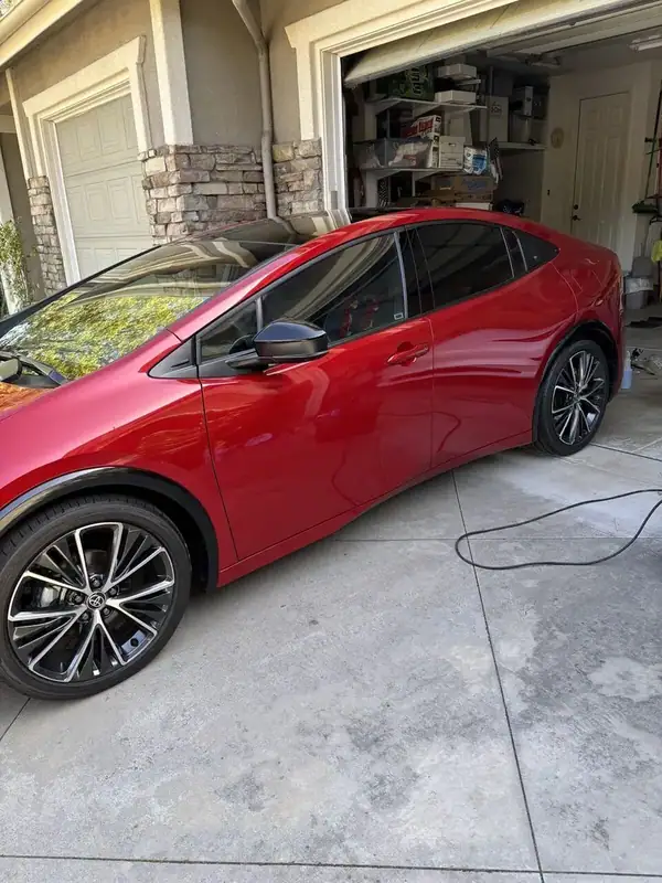 Red Toyota Prius Limited rear quarter glass with dark ceramic IR tint — mobile window tinting San Diego
