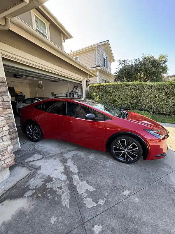 Red Toyota Prius Limited side profile with completed ceramic window tint and panoramic glass roof — San Diego mobile auto window tinting